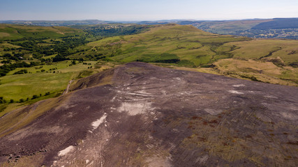 Aerial drone view of a large, buried landfill dump site in Wales