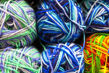 Store shelf with color yarn for knitting with needles, crochet hook.