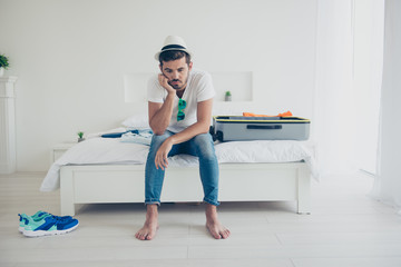 It seems there will not be a trip. Full-legh full-body portrait of frustrated guy rests his hand on...