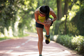Female runner suffering with pain on sports running knee injury .