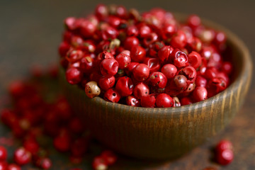 Rose pepper in a wooden bowl.