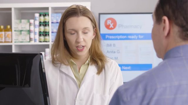 Customer discussing his medication with his pharmacist