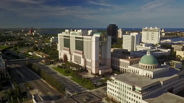 Aerial crane up looking at courthouse with intracoastal and ocean on background