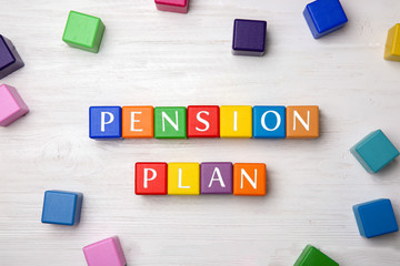 Colorful cubes with text PENSION PLAN on wooden background