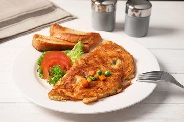 Omelet with vegetables on plate served for breakfast