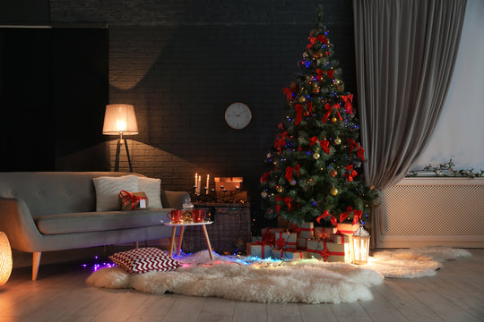 Stylish room interior with decorated Christmas tree