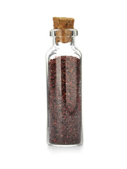 Glass bottle with spice on white background