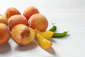 Fototapeta na wymiar Fresh sweet peaches on wooden table, closeup