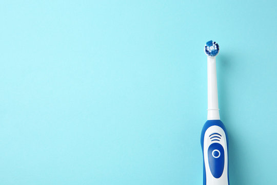 Electric toothbrush on color background. Dental care