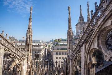 Fototapeta na wymiar view of Gothic architecture and art on the roof of Milan Cathedral (Duomo di Milano), Italy