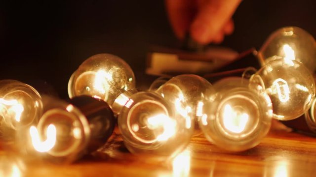man adjusts dimmer the brightness of incandescent lamps