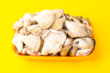 Container with fresh mushrooms