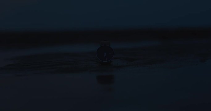 Time-lapse of a real watch on a beach during the sunset.
