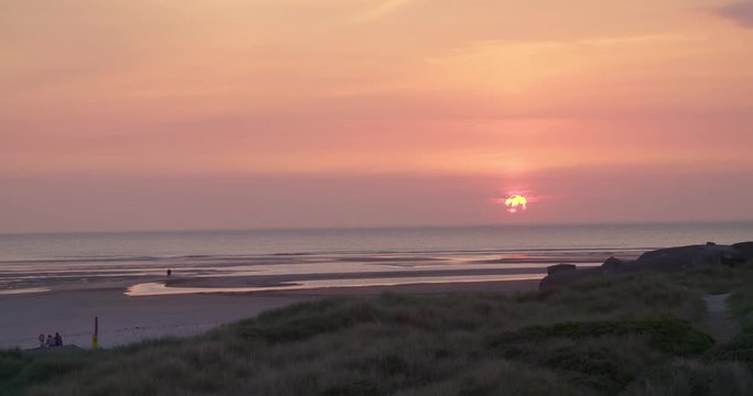 Gold hour sunset in Denmark Scandinavia Europe on beach with people walking