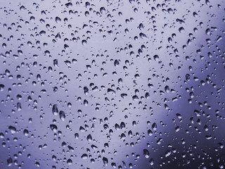 drops of water on the glass. toned background.