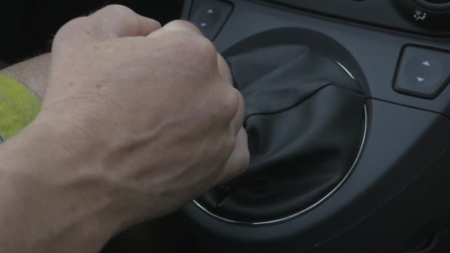 Shifting a gear in a car.