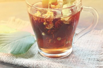 lime tea. and linden flowers on a wooden background.