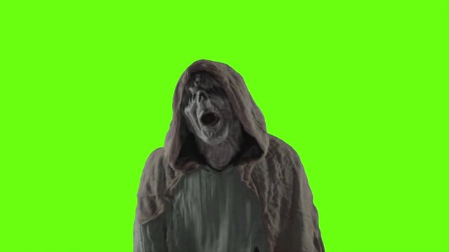 A scary monster with a green screen background.