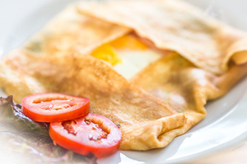 omelette, a mixture of eggs and other ingredients such as grilled sausage, roasted mushroom, fresh tomatoes, baked bread, makes the taste more delicious.