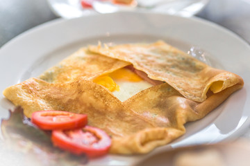 omelette, a mixture of eggs and other ingredients such as grilled sausage, roasted mushroom, fresh tomatoes, baked bread, makes the taste more delicious.