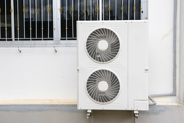 Exterior air conditioning compressor outdoor unit on a wall