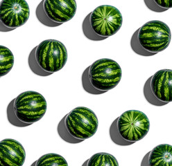 Whole watermelons arranged on a white background © Tierney