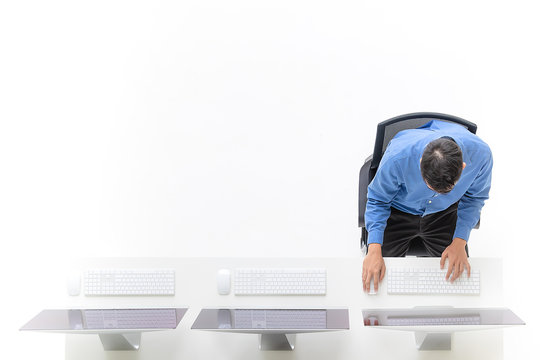 Young Businessman Sitting In The Office With Modern Computer, Taken Form Top View, Bird Eye View Angle With Copy Space On Left Area