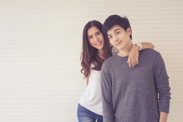Asain coupld standing together with manner of love, beautiful girl and hansome boy pose to camera