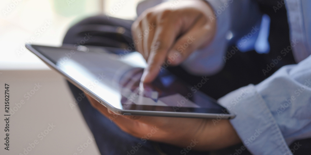 Poster digital tablet computer close up man using tablet hands man multitasking with isolated screen