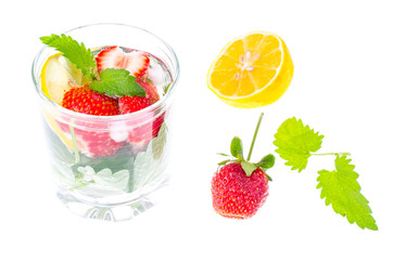 Cold summer drink with strawberries, lemon and mint