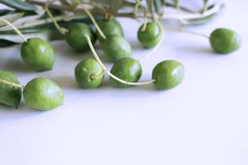 Fresh green olives isolated on white background close up.Blurred background.