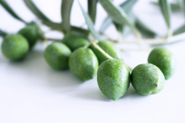 Fresh green olives isolated on white background close up.Blurred background.