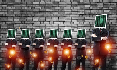 Businessmen with monitors instead of head.