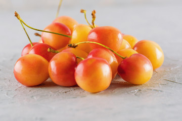 Ripe yellow-red colored cherry macro close-up. Juicy fruit, diet, healthy lifestyle.
