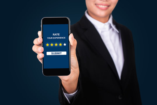 Smartphone or mobile phone with text rate your experience on the screen. Customer satisfaction survey concept