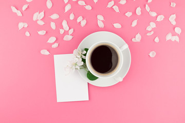 Flat lay of coffee, letter mockup and white petals