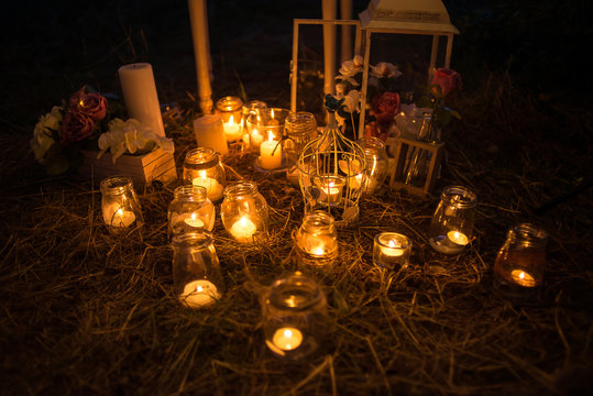 Night decorated zone outdoor; candles, lantern, board, vase, jar, lead board