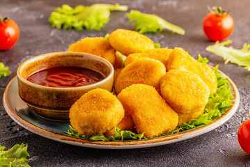 Chicken breast nuggets with sauces.