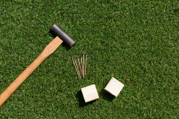 tools(hammer, nail, wood) on turf