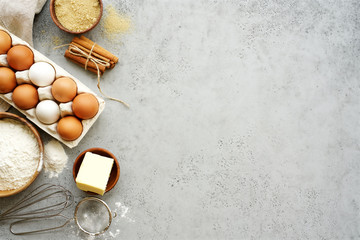 Ingredients and cooking tools for biscuit. Flour, sugar, butter, eggs, cinnamon. Gray food...