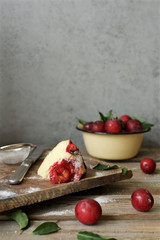 Slice of homemade plum pie on cutting board