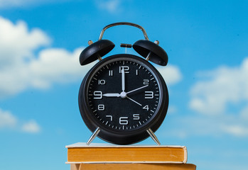 Alarm clock. Clock. Time concept. Time. Summer time. Sky background. Life. 