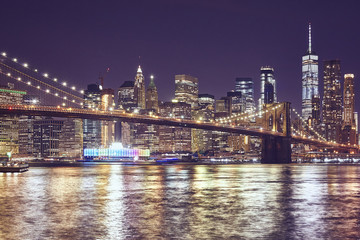 Obraz premium Brooklyn Bridge and Manhattan at night, color toned picture, New York City, USA.