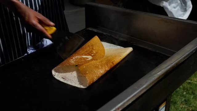 Chef from Rishis Glasgow wrapping the potato filling with dosa