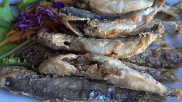 Fried fish on a plate. HD video
