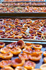 Homemade dried apricots. A leaf with halves of apricots