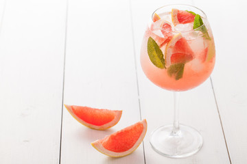 Citrus lemonade water with grapefruit sliced , healthy and detox water drink in summer on concrete table.