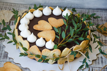 Cheesecake with gingerbread cookies on wood with greenery decoration
