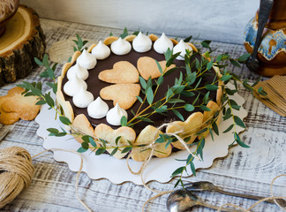 Cheesecake with gingerbread cookies on wood with greenery decoration