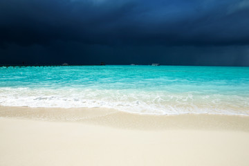 tropical beach in Maldives with few palm trees and blue lagoon